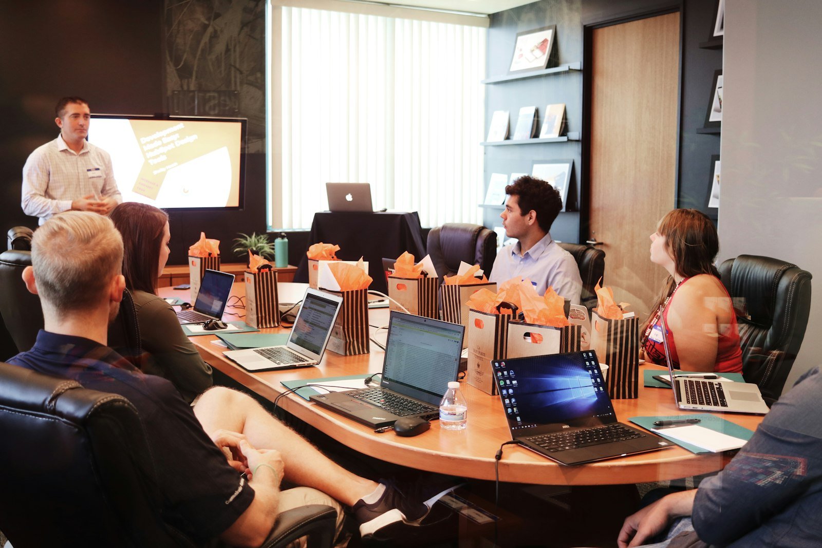 Marketing team planning a campaign around a laptop